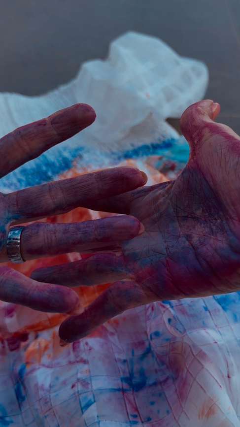Close-up of hand covered in colorful paint